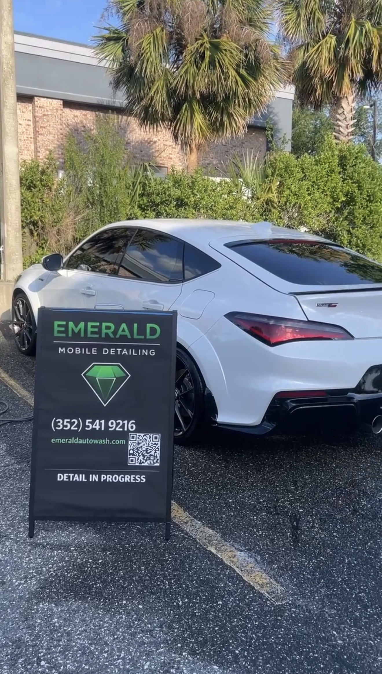 Emerald Mobile Detailing sign beside a freshly detailed white Acura
